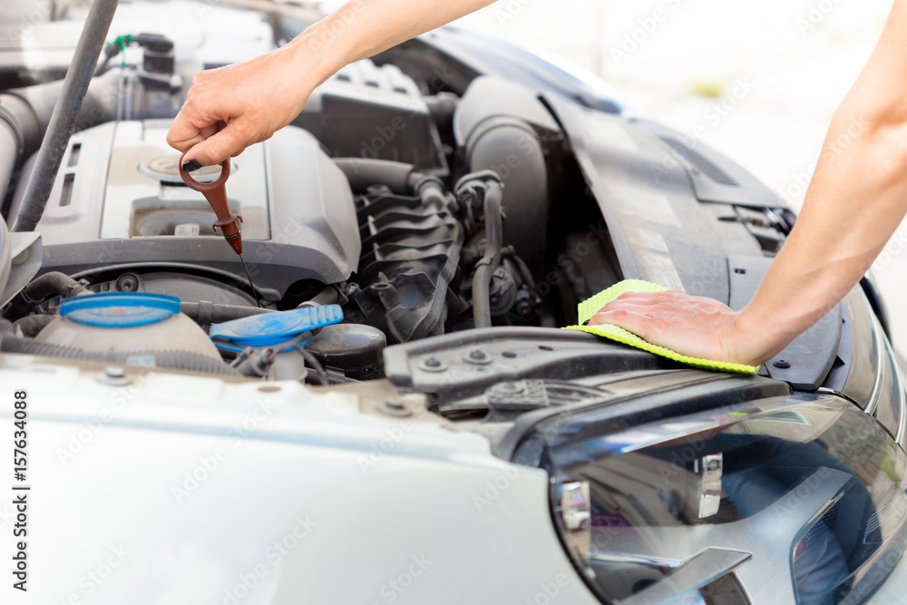 Hand with microfiber cloth cleaning car Hand with microfiber cloth cleaning car