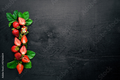 Fresh strawberries. Healthy food. On Wooden background. Top view. Free space.