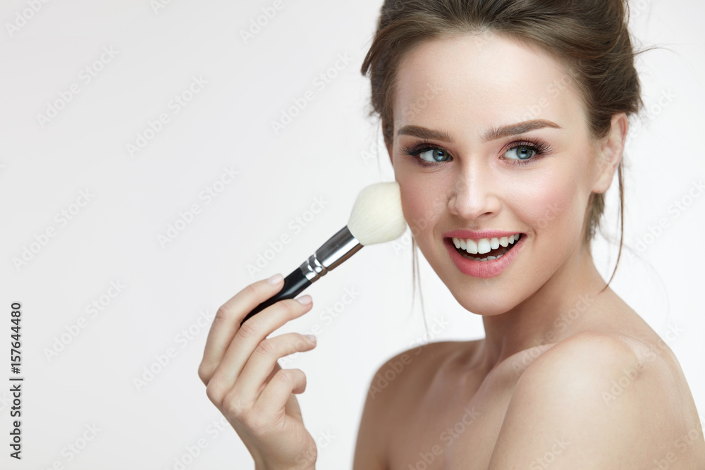 Beauty Face Makeup. Beautiful Smiling Girl Applying Loose Blush
