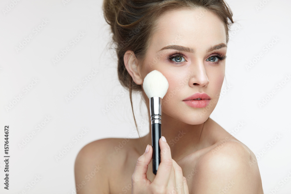 Facial Makeup. Beautiful Female Applying Blush With Brush Facial Makeup. Beautiful Female Applying Blush With Brush