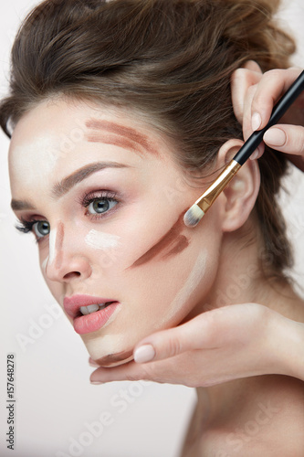 Beauty Makeup. Beautiful Woman Applying Contouring Lines On Face