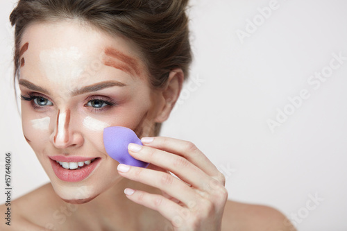 Face Makeup Beauty. Beautiful Female Applying Makeup With Sponge