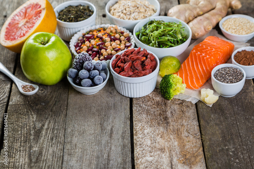 Selection of superfoods on rustic background