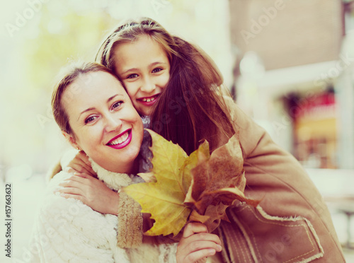 Positive woman with little girl