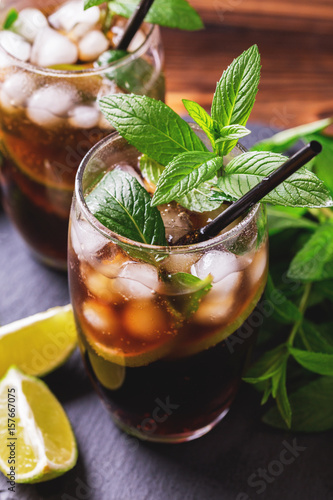 Cuba Libre cocktail with cola, lime, rum and peppermint
