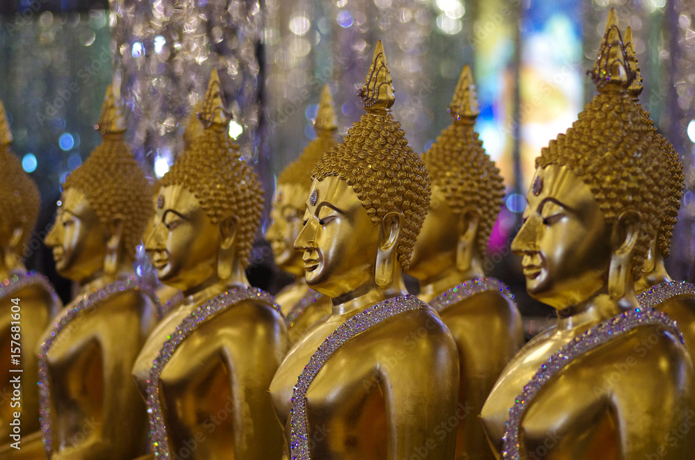 Fototapeta premium UTHAI THANI PROVINCE, THAILAND - August, 2016: Golden Buddha statue at Cathedral glass, Wat Tha Sung or Wat Chantharam