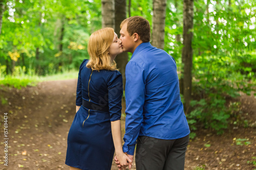 Romantic young couple in love relaxing outdoors in park