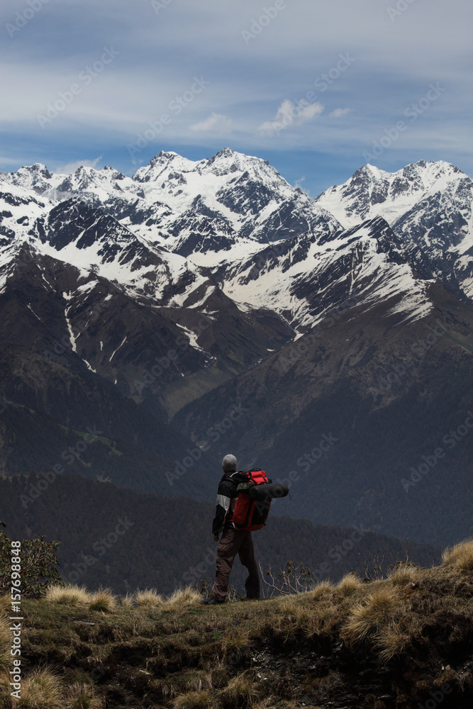Trekker looking to the mighty Himalayas during Rudranath Trek in Uttarakhand, India