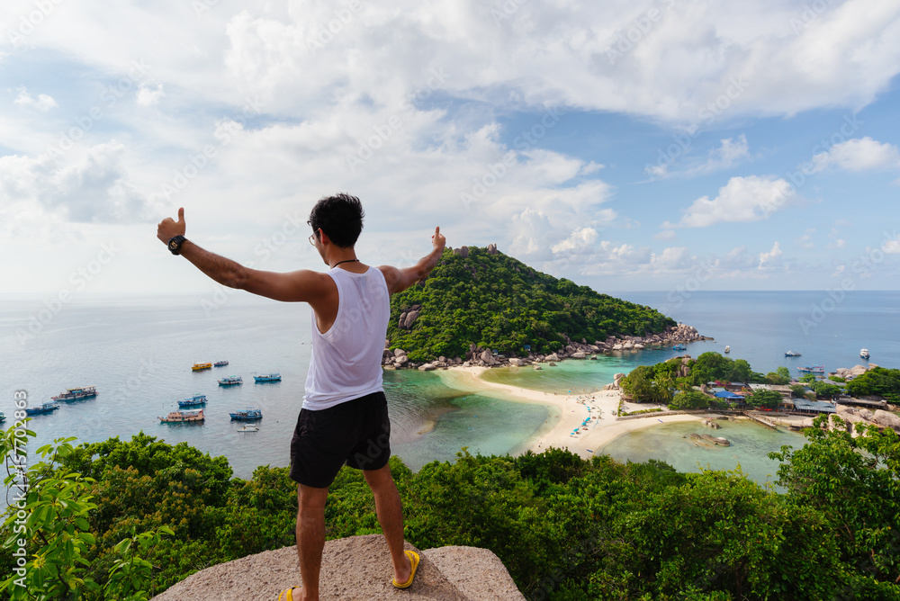 Asia young Man Traveller   at viewpoint on island,Travel Vacation Lifestyle summer Concept.Tropical paradise on the island of Koh nang yuan in Thailand,vintage tone