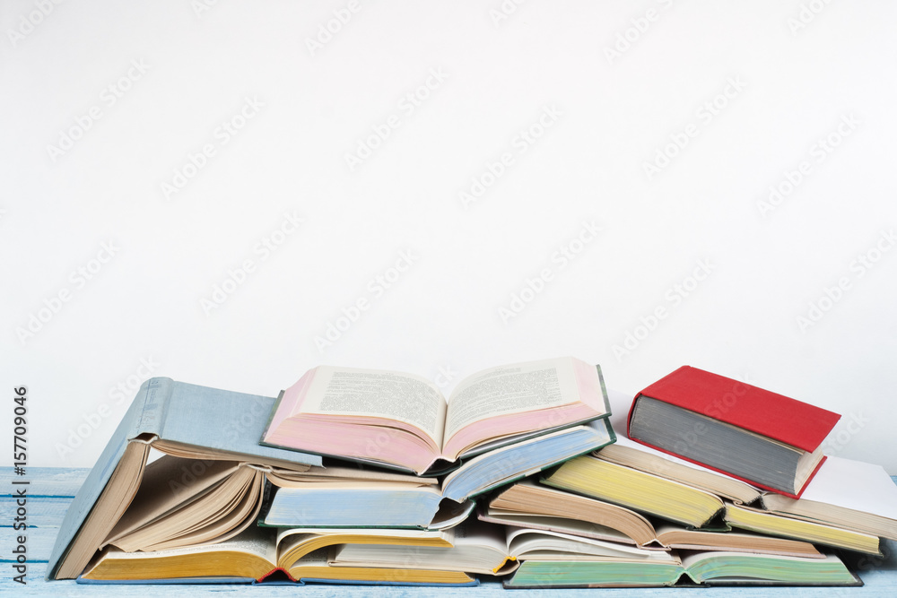 Open book, hardback colorful books on wooden table. Back to school. Copy space for text. Education business concept. Open book, hardback colorful books on wooden table. Back to school. Copy space for text. Education business concept.