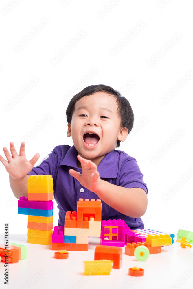 Kid boy playing with blocks from toy constructor isolated Kid boy playing with blocks from toy constructor isolated