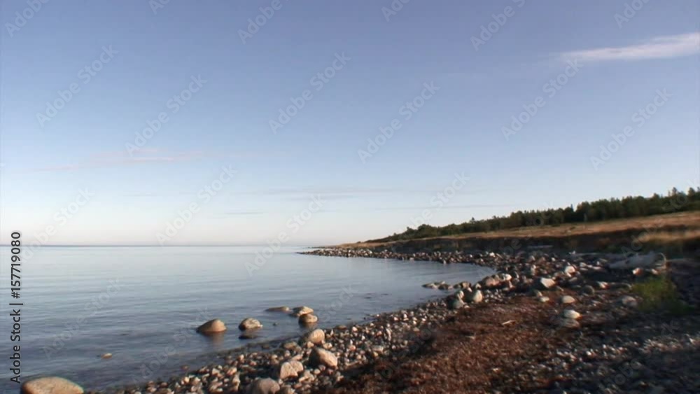 Coast and calm water of White Sea. Beautiful landscape of wild nature. Quiet and calm ecotourism in Russia. Panorama of way to cold Karelia. Coast and calm water of White Sea. Beautiful landscape of wild nature. Quiet and calm ecotourism in Russia. Panorama of way to cold Karelia.