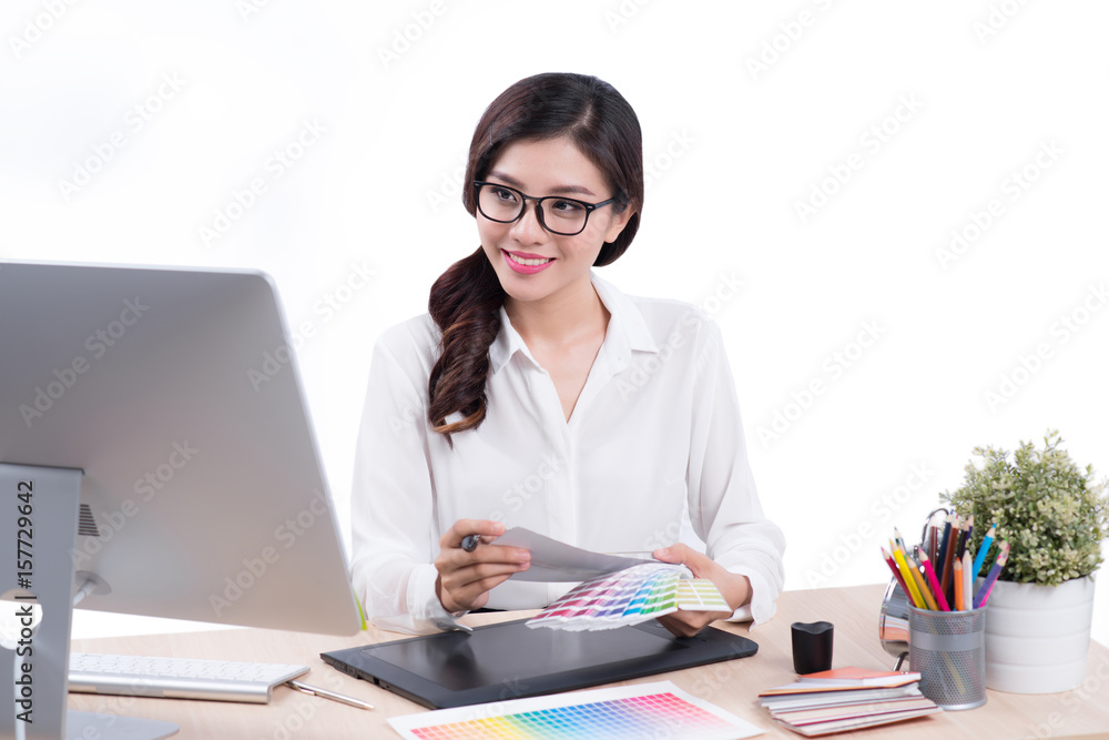 Graphic designer at work. Asian woman sitting on desk. Graphic designer at work. Asian woman sitting on desk.