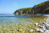 Clear blue sea water and rocky shore. Primorye, Russia.
