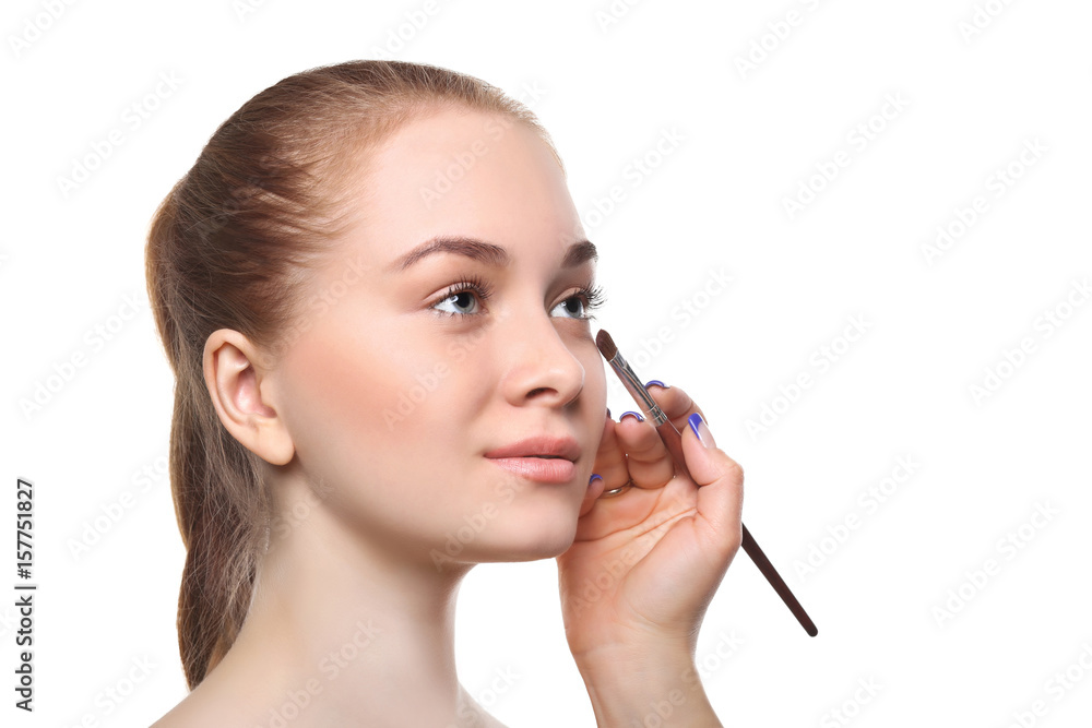 Applying female makeup, isolated on white Applying female makeup, isolated on white