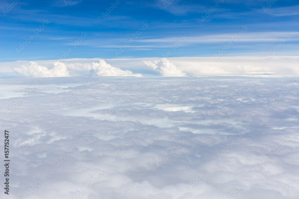 Beautiful fluffy white cumulus clouds on blue sky background.