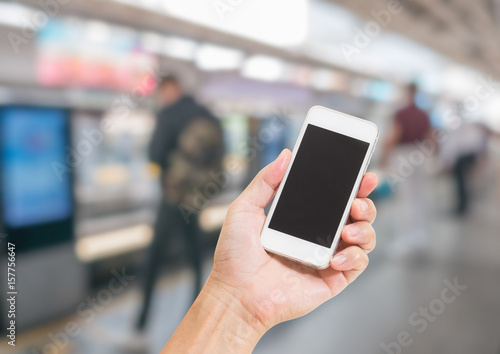Hand holding mobile phone with blur cityscape background use for digital marketing concept