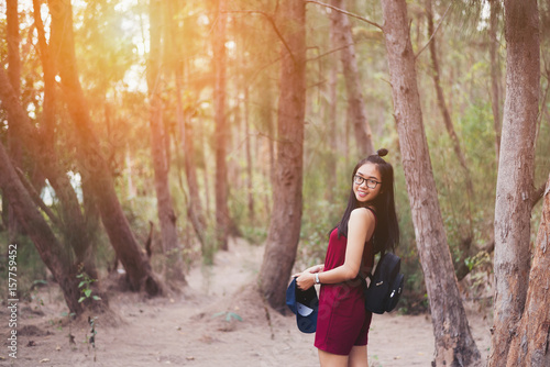 The girl smiled in a pine forest at  the summer season.Travel concept © palidachan