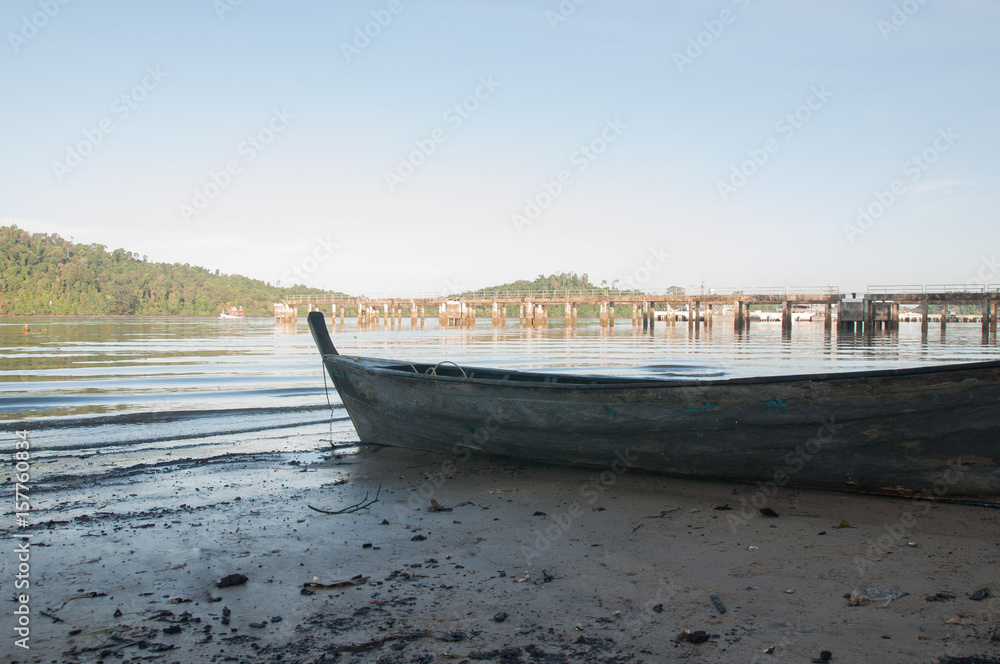 Old and small wooden fisheries boat on the beach