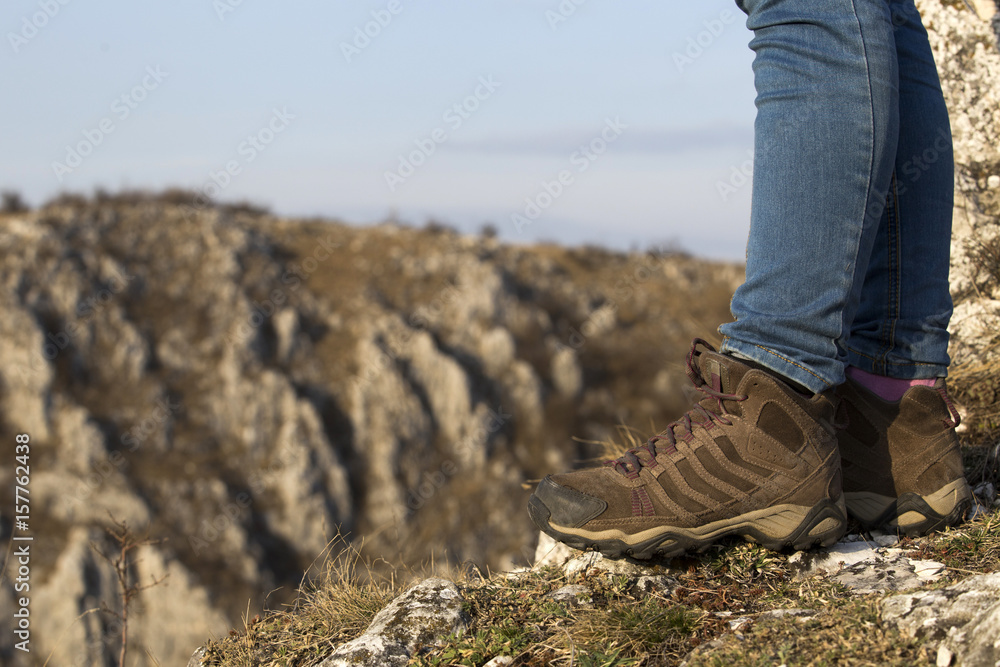 Hiking boot closeup on mountain rocks Hiking boot closeup on mountain rocks