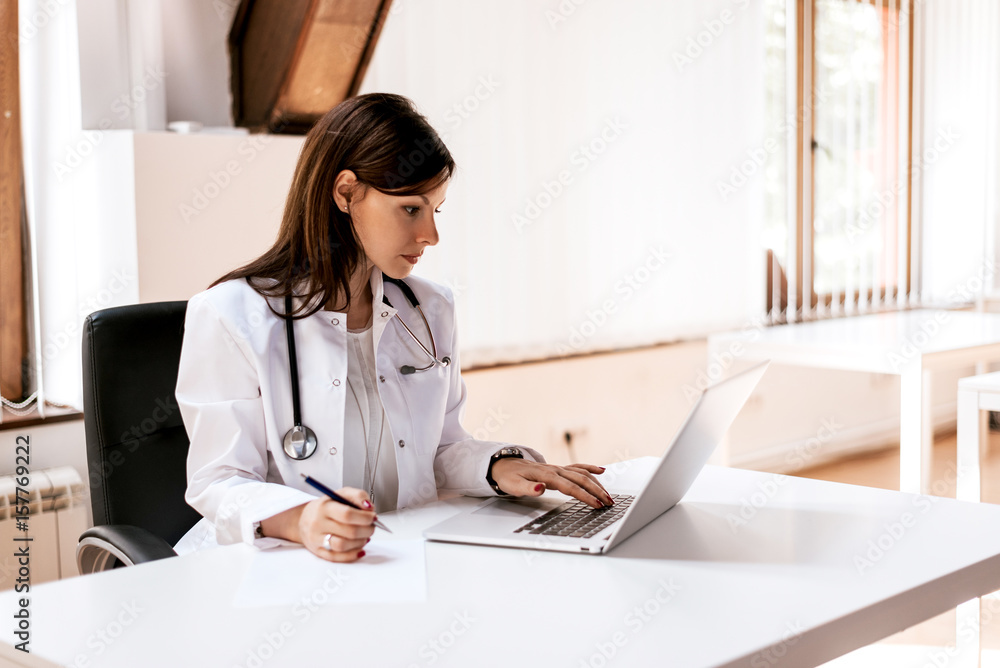 Medical doctor woman working on laptop in office Medical doctor woman working on laptop in office