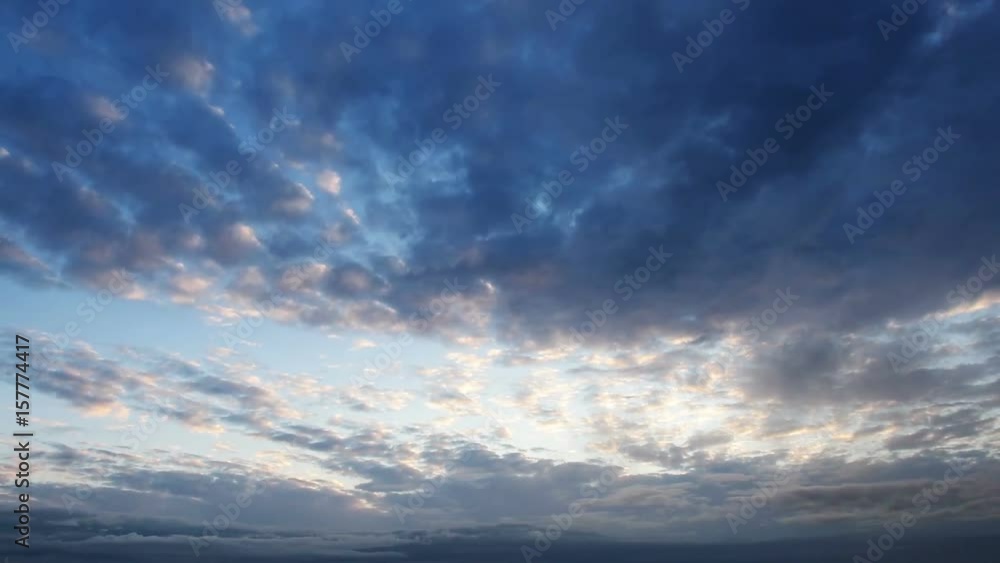 Beautiful cloudscape with large, building clouds and sunrise breaking through cloud mass. Beautiful cloudscape with large, building clouds and sunrise breaking through cloud mass.