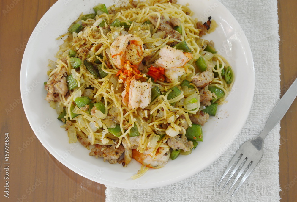 spicy stir fried pepper spaghetti with shrimp and minced pork on plate