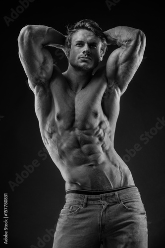 portrait of strong Athletic Fitness man over black background