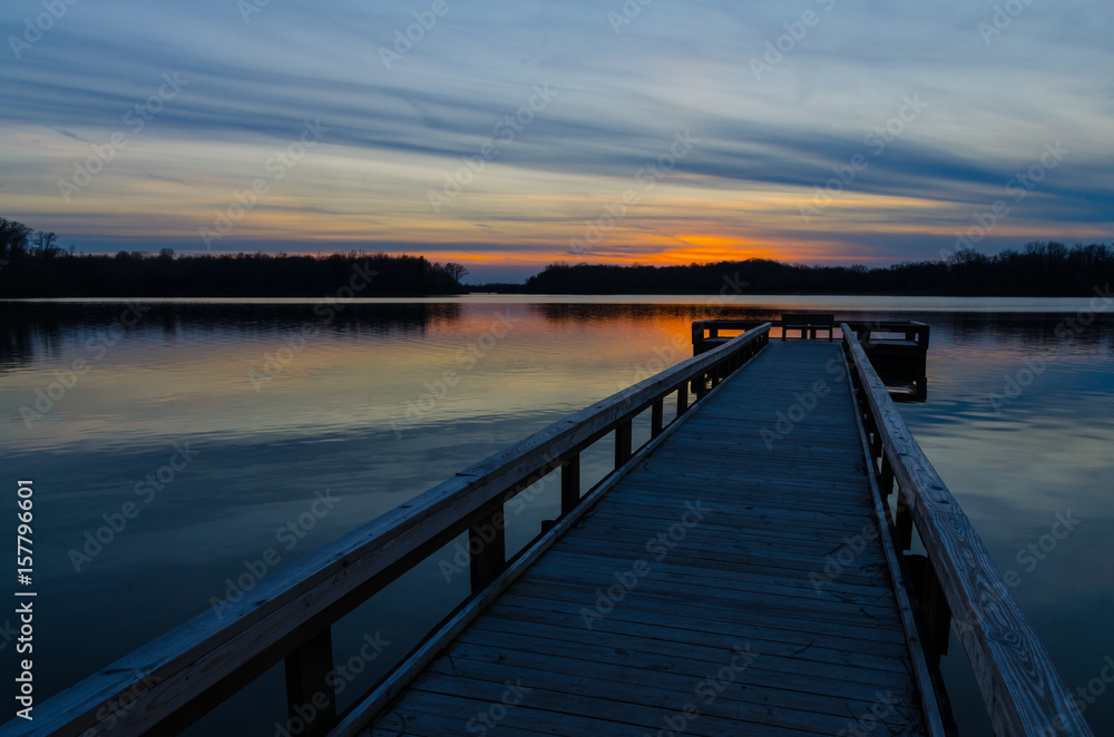 Sunset at the end of the wood fishing pier at  Potato Creek State Park in North Liberty, Indiana