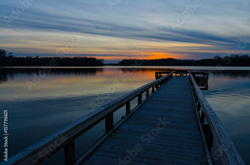 Sunset at the end of the wood fishing pier at Potato Creek State Park in North Liberty, Indiana