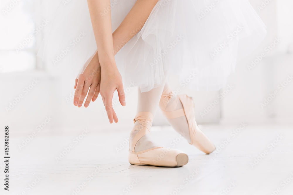Young ballerina dancing, closeup on legs and shoes, standing in pointe position. Young ballerina dancing, closeup on legs and shoes, standing in pointe position.