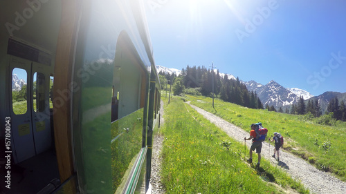 MONT BLANC, FRANCE - circa JUL, 2017: POV from Old fashioned Montblanc tramway to two hikkers. Nid d'Aigle the is last station Mont Blanc Tramway at 2386 meters in Chamonix, France photo