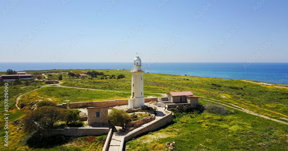 Ancient lighthouse near Mediterranean Sea . Summer landscape. Cyprus.City resort.	