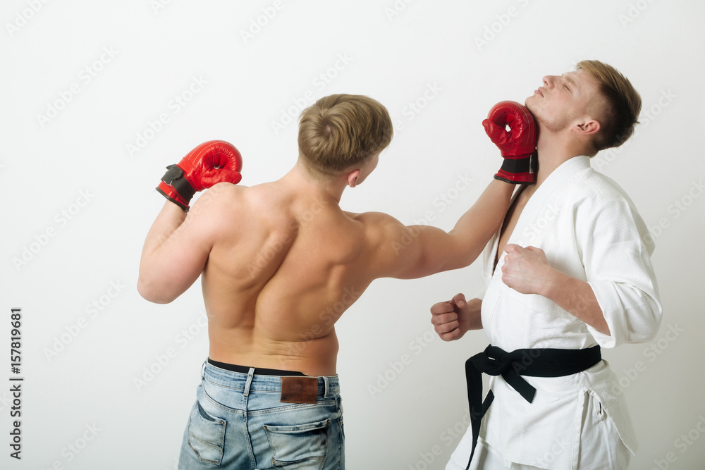 boxer punching young karate athlete