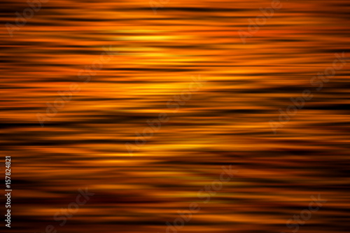 Abstact background from water surface with light of sunset.