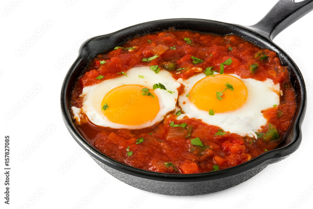 Mexican breakfast: Huevos rancheros in iron frying pan isolated on white background
