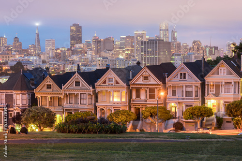 Dusk Over The Painted Ladies. Iconic Victorian Houses and San Francisco Skyline in Alamo Square, San Francisco, California, USA.