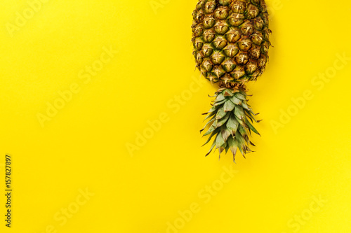 Half slice of beautiful fresh appetizing tasty pineapple on yellow bright background. Top View. Horizontal. Copy Space. Conceptual.