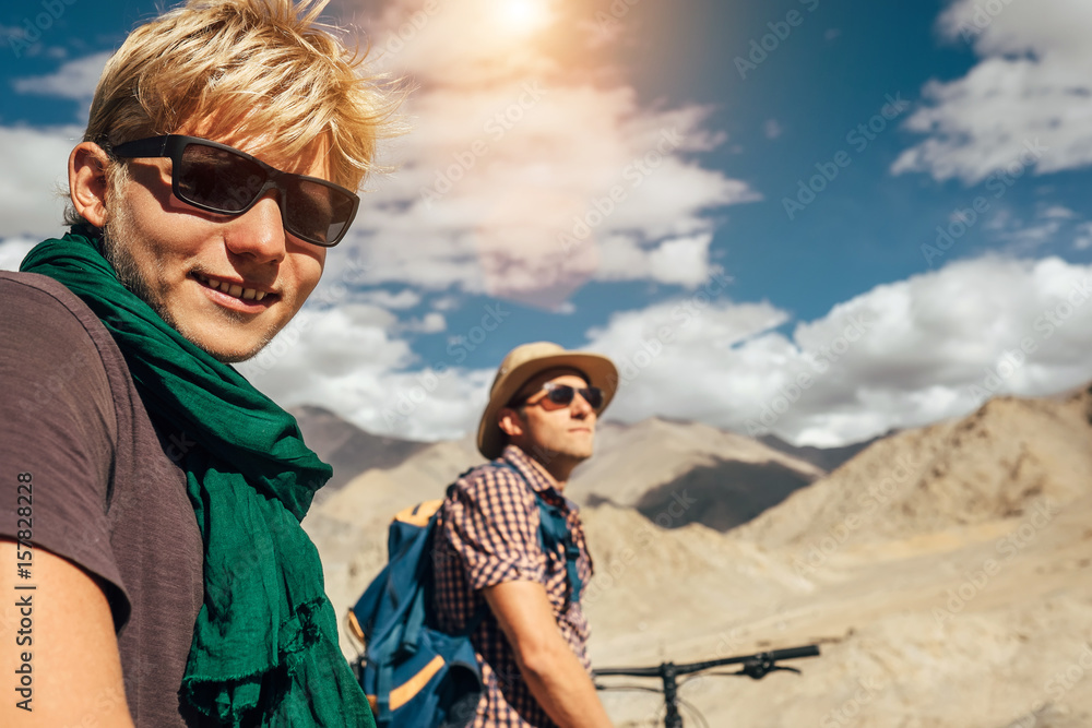 Two travelers on bycikles in high mountain