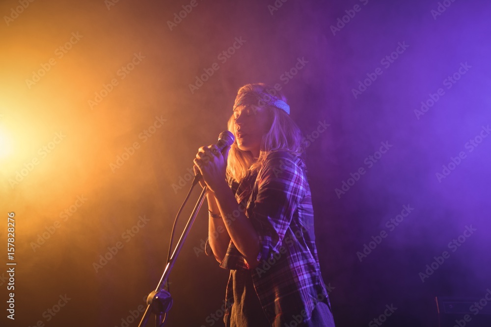 Female singer performing in illuminated nightclub Female singer performing in illuminated nightclub