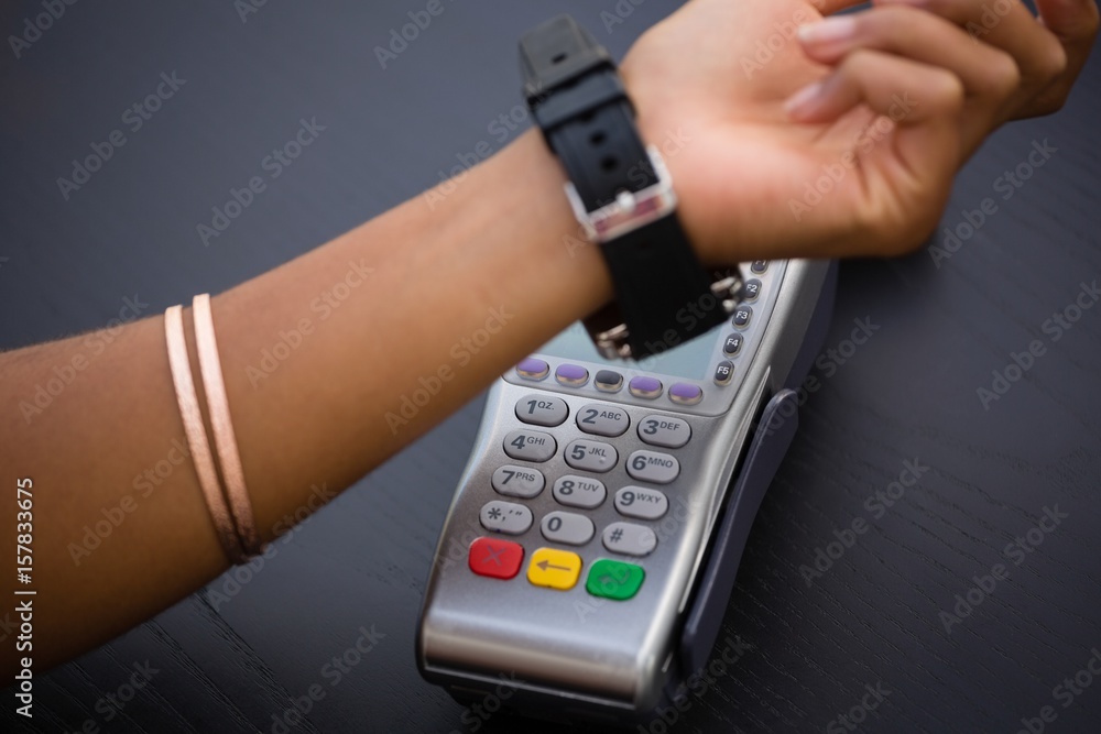 Hand of woman making payment via smart watch