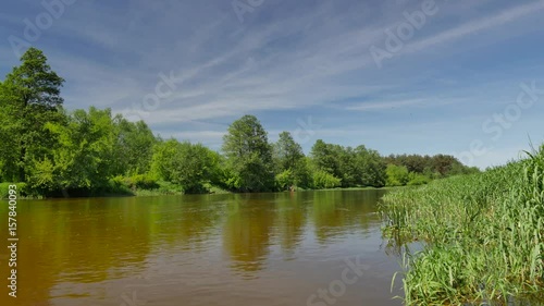 Beautiful day at river bank. Small river Wkra in the middle of Poland. photo