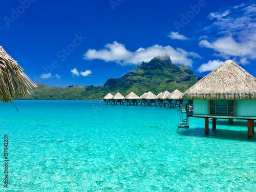 Beautiful turquoise lagoon of Bora Bora and the overwater bungalows of a luxury resort