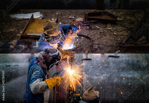 Welder is welding big pipe at construction site