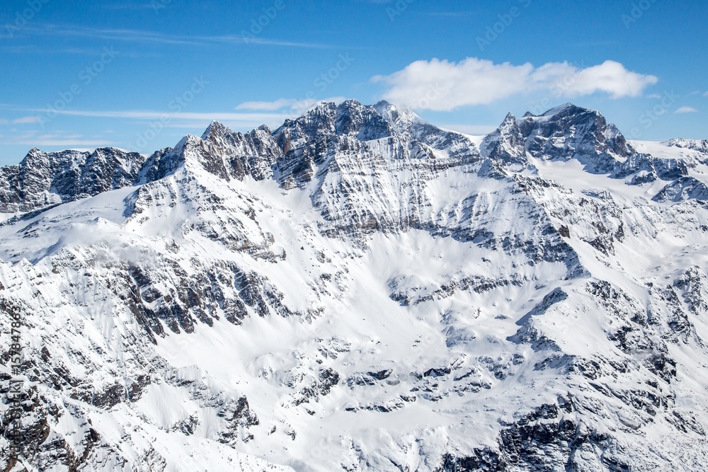 Aerial view of the Bernina Group in its winter version with the Sasso d'Entova and Pizzo Tremogge in the foreground and the Pizzo Bernina in the background, Valmalenco, Valtellina, Italy