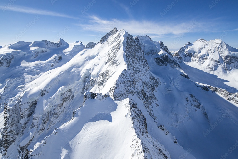 Aerial view of the long crest of ice and rock that takes to Pizzo Bernina. Engadine, Canton Grigioni, Switzerland.