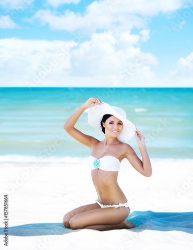 Beautiful  young  attractive girl in bikini taking a rest near the sea. Vacation  resort  holiday concept.