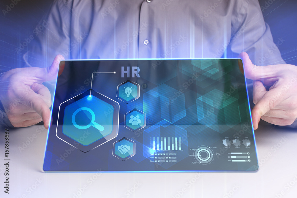 Fototapeta premium Business, Technology, Internet and network concept. Young businessman working on a virtual screen of the future and sees the inscription: HR