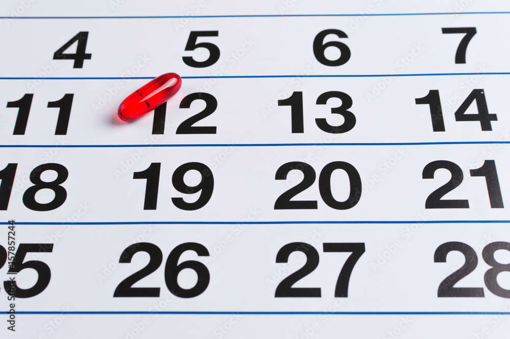 Red pill on the calendar. Schedule medication Red pill on the calendar. Schedule medication