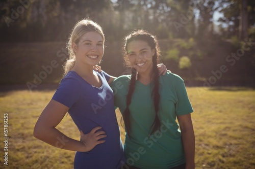 Portrait of happy friends standing in boot camp